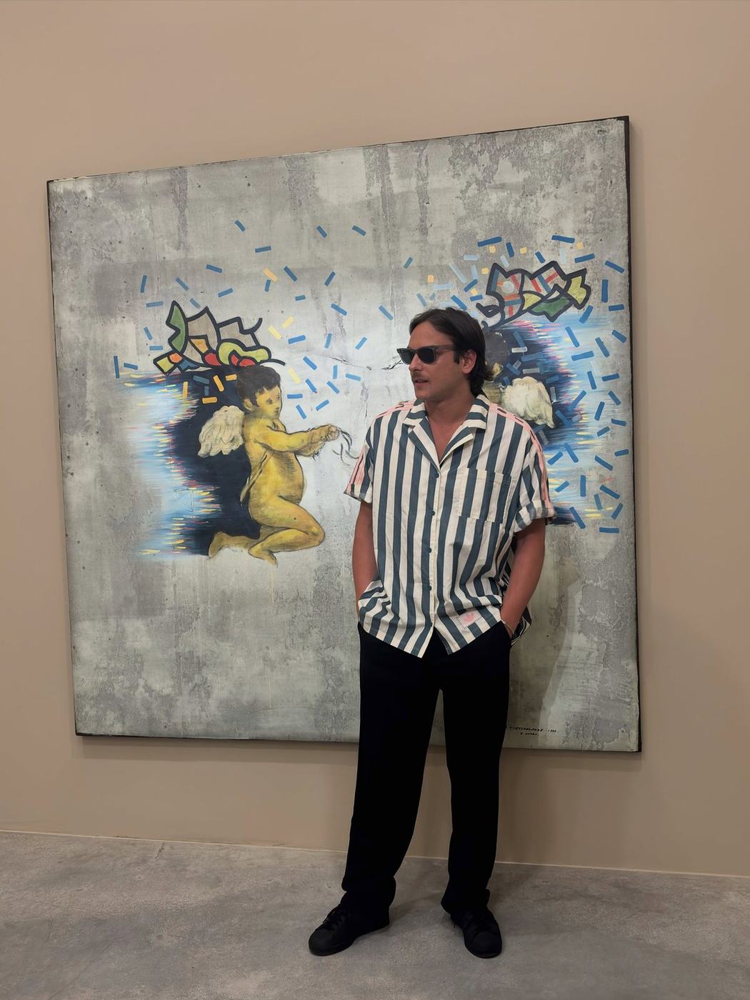 Luka Lemini next to his painting